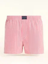 Bóxer de algodón blanco con estampado de flores pequeñas color celeste, con cintura elástica y logo de la marca en el centro.