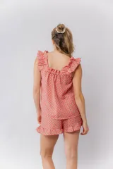 Conjunto de pijama de algodón con estampado floral pequeño, compuesto por una musculosa de escote recto con frunces y volados en los hombros, y un short con cintura elástica y terminación con volado.
