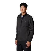 Campera polar Columbia con cierre frontal completo, cuello alto y bolsillo con cierre en el pecho. Presenta un diseño jaspeado en tonos oscuros y el logo de la marca aplicado en el pecho.