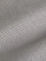 Pantalón chino de sarga elástica, color gris claro, de corte slim y talle medio. Incluye un cinturón negro con hebilla en forma de D.