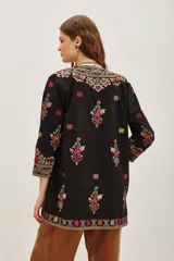 Kimono negro de algodón con bordados étnicos multicolores en el frente, mangas y ruedo. Posee un diseño abierto y mangas tres cuartos.