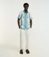 Pantalón de corte recto y estilo sastre de la marca Marfinno, color blanco, con cintura con trabillas, cierre frontal tradicional y bolsillos laterales. Confeccionado en una mezcla de liocel y algodón.