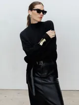 Sweater negro de cuello alto y corte holgado.