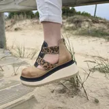 Zapatos de cuero con plataforma alta en tonos marrones y beige, diseño de tiras cruzadas en el empeine y laterales abiertos.