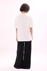 Remera blanca de manga corta, corte oversize, con estampa colorida de motivos marinos y botánicos en el frente.