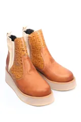 Botín de cuero color marrón con textura tipo piel de cocodrilo en la caña y cuero liso en el resto del botín. Tiene cierre lateral y suela de goma color beige.