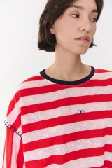 Remera de manga larga con corte oversized, color azul marino con cuello redondo en contraste color marrón. Presenta costuras decorativas a contratono hechas a mano en la zona de los hombros y logo bordado en el centro del pecho.