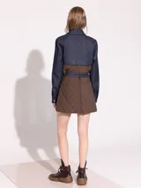 Minifalda marrón con diseño acolchado a cuadros y cinturón de denim azul.