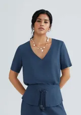 Blusa azul de lino con escote en V y mangas cortas.