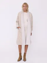 Tapado largo color beige, reversible con interior de piel sintética blanca.