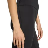 Calza deportiva Adidas de mujer, color negro, de tiro alto y corte semi oxford con botamanga acampanada.