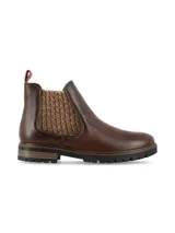 Botin chelsea Freya de cuero color marrón chocolate con elásticos laterales de tejido grueso texturizado en tonos marrones y beige, suela track y tirador trasero en color bordo.