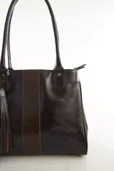 Bolso tote de cuero genuino color bordó con asas largas para hombro. Presenta una franja central con textura de cocodrilo y un adorno lateral de flecos.