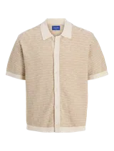 Polo de manga corta con cuello tipo polo y cierre con botones. Tejido de punto plano estructurado con textura ligera.