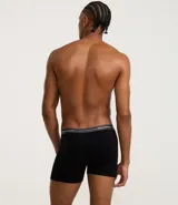 Calzoncillo tipo bóxer para hombre, color negro, confeccionado principalmente en algodón con un pequeño porcentaje de elastano. Presenta una cintura elástica ancha con franjas horizontales en tonos de gris y el texto "LUPO UNDERWEAR" repetido.