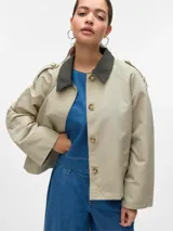 Campera corta de estilo parka con cuello camisero en contraste, cierre frontal con botones ocultos y bolsillos laterales. Presenta un diseño de corte recto con detalles en los hombros y mangas largas.