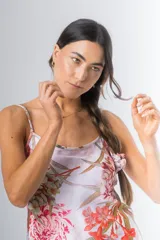 Camisón de seda estampado con diseño floral en tonos rosados, rojos y verdes, con breteles finos y largo por encima de la rodilla.