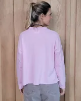 Sweater de tejido de punto color turquesa, con cuello en V y mangas largas de corte holgado.