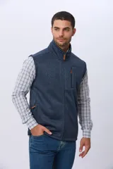 Chaleco de felpa en color azul, con cierre frontal completo, cuello alto y bolsillo vertical en el pecho.