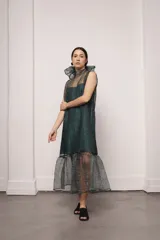 Vestido largo color ocre con estampado de cuadrados dorados, cuello alto y corte amplio. Incluye viso liso al tono.