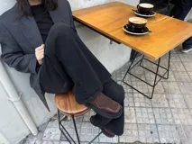 Botas tipo chelsea de caña baja, confeccionadas en una combinación de cuero gamuzado y cuero texturizado en tono marrón oscuro. Presentan una suela track de plataforma gruesa y elásticos laterales negros.