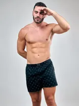 Bóxer de algodón blanco con estampado de flores pequeñas color celeste, con cintura elástica y logo de la marca en el centro.