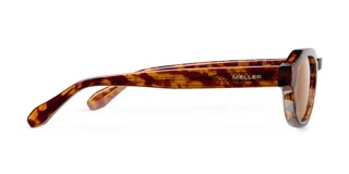 Lentes de sol con montura geométrica de acetato color carey (tortoise) y cristales marrones polarizados. El diseño combina una parte superior plana con una parte inferior redondeada.