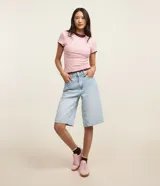 Blusa básica de manga corta y cuello redondo, confeccionada en viscosa texturizada de canalé con elastano y detalle de terminación ondulada en el bajo.