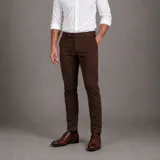 Pantalón chino de gabardina color marrón oscuro, de corte entallado y diseño clásico con bolsillos laterales y traseros.