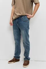 Pantalón de jean color azul clásico, de corte regular y diseño recto, con lavado sutil.
