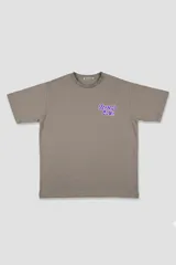 Remera color topo con estampa en la espalda de un extraterrestre, un skater y la frase "The truth is out there".