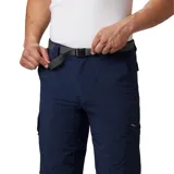 Pantalón de trekking azul marino con cinturón negro, cintura elástica parcial, refuerzo en la entrepierna y protección solar UPF 50.