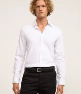 Pantalón slim de sastrería de color gris claro, confeccionado en sarga de algodón con elastano, con cierre frontal de botón y cremallera, y bolsillos.