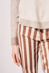 Sweater de punto color beige con mangas marrones y cuello y ruedo en azul marino.