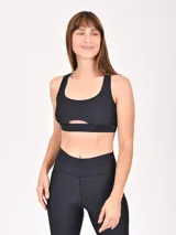 Top deportivo negro con breteles anchos y abertura en el centro del pecho.