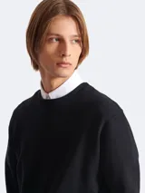 Sweatshirt negra de Balmain con cuello redondo, mangas largas y logo estampado en blanco en el lateral inferior.