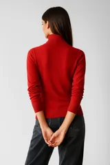 Polera de tejido de punto color blanco, con cuello redondo y manga larga.