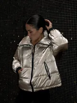 Campera puffer negra metalizada con cierre frontal, cuello alto y bolsillos laterales.