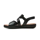Sandalia plana de cuero color negro, con diseño de tiras cruzadas, cierre ajustable con velcro en el empeine y plantilla acolchada en tono tostado.