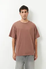 Remerón unisex verde militar de manga corta y cuello redondo, con pequeño estampado lateral en el frente y otro grande en la espalda.