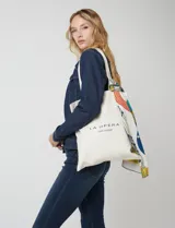 Tote bag de tela color crudo con estampado tipográfico negro en el frente que dice 1926 y La Opera. Cuenta con asas largas para llevar al hombro.
