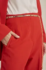 Cinto dorado con piedras de colores y cadena para ajustar el tamaño.