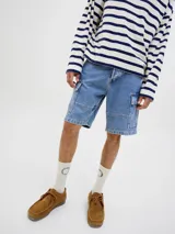 Bermuda cargo de jean baggy fit con tiro alto, múltiples bolsillos y pernera amplia. Presenta un acabado stonewash con efecto desgastado.