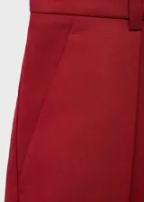 Short de tiro alto color rojo, de diseño recto y estilo sastrero, con trabillas, cierre delantero y bolsillos laterales.