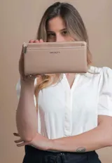 Billetera de mujer tipo sobre con correa de mano extraíble, confeccionada en material texturizado color tostado. Presenta un bolsillo frontal con cierre, compartimentos internos para tarjetas y logo de la marca grabado en el frente.