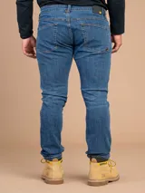 Jeans de corte skinny con tecnología Coolmax para control de temperatura y secado rápido. Presenta un lavado azul clásico con costuras en contraste y cierre frontal con botón y cremallera.