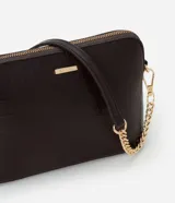 Cartera bandolera pequeña de Satinato, confeccionada en poliuretano con textura tipo cocodrilo. Presenta cierre superior con cremallera, herrajes dorados y una correa de cadena metálica desmontable.