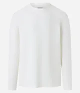 Remera de manga larga con cuello redondo y textura acanalada, confeccionada en una mezcla de poliéster y algodón.