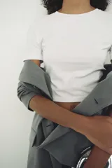 Camiseta cropped color amarillo, de corte slim fit, cuello redondo y manga corta.