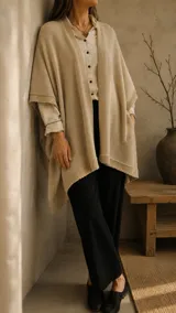 Ruana de hilo de algodón color beige, de diseño amplio y liviano con terminaciones tejidas en los bordes.